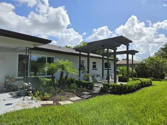 Back of property with a patio area, a pergola, and a yard