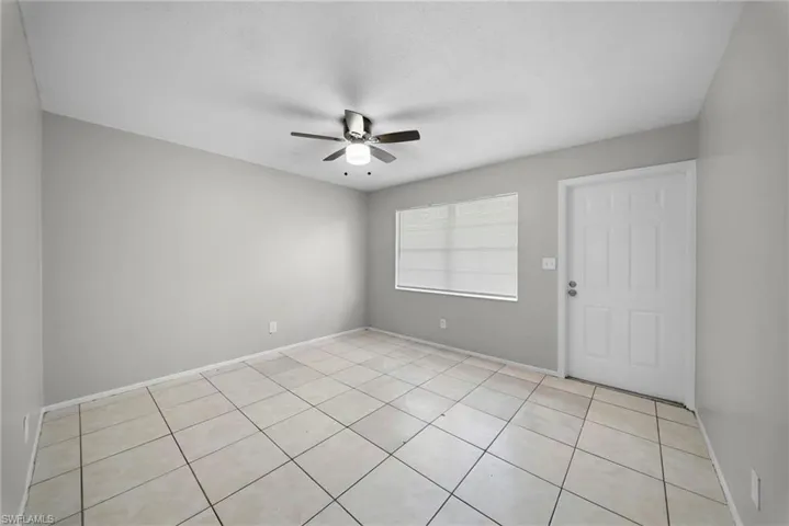 Unfurnished room featuring ceiling fan and light tile patterned floors