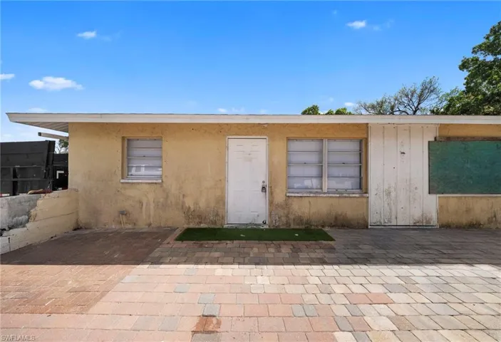 View of front of property featuring a patio area and stucco siding