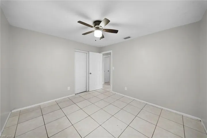 Unfurnished bedroom featuring a ceiling fan and a closet