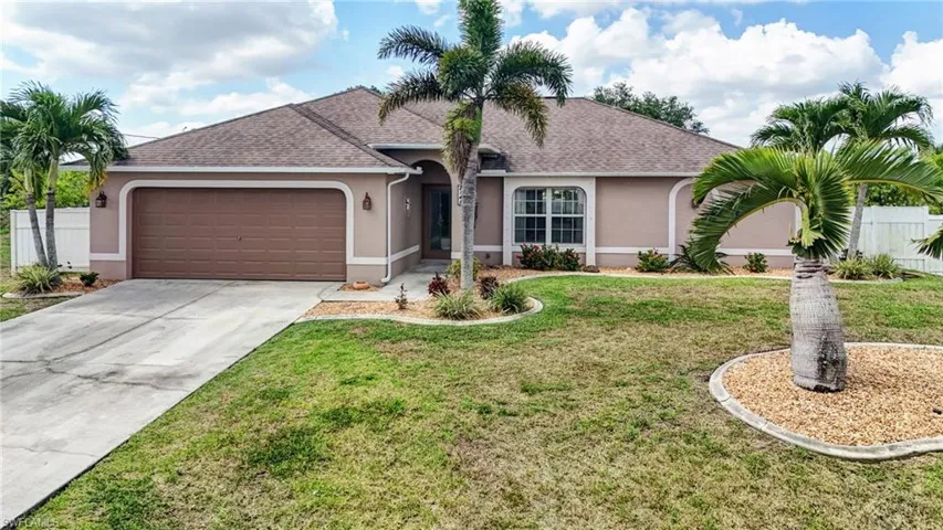 Single story home with stucco siding, a garage, roof with shingles, and concrete driveway