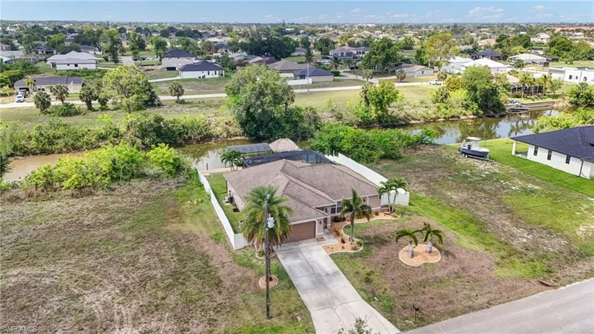 Aerial perspective of suburban area featuring a large body of water
