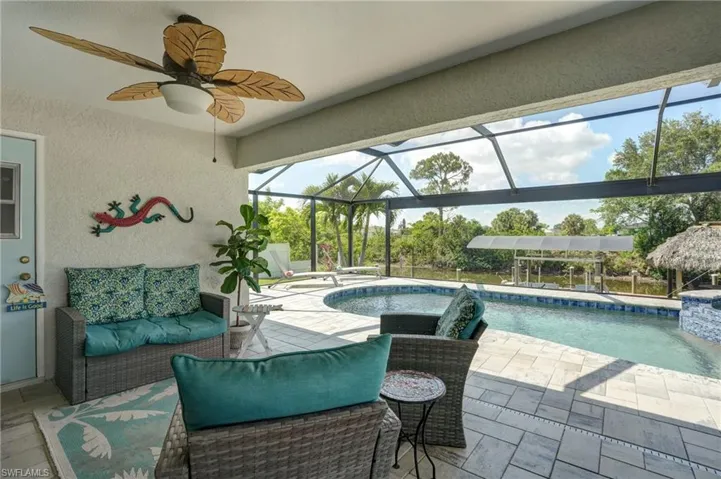 Outdoor pool with a patio, an outdoor living space, and ceiling fan