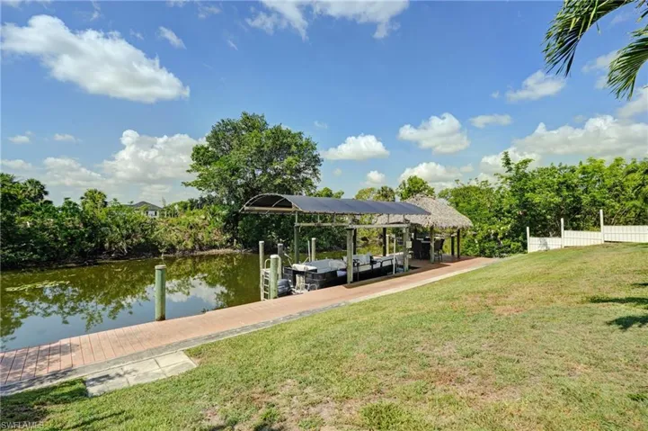 Dock area with a water view and boat lift