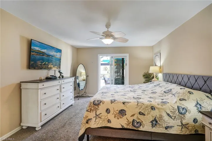 Bedroom featuring light colored carpet, access to outside, baseboards, and ceiling fan
