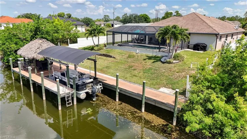 Dock with a lanai and a water view
