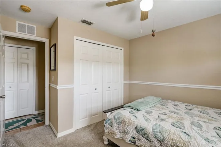 Bedroom featuring a closet, carpet flooring, baseboards, and ceiling fan