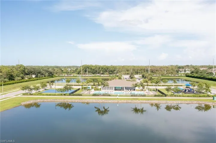 Birds eye view of property with a water view