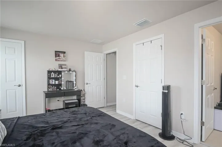 Bedroom with light hardwood / wood-style flooring