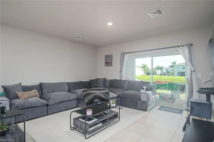 Living room featuring light tile patterned floors