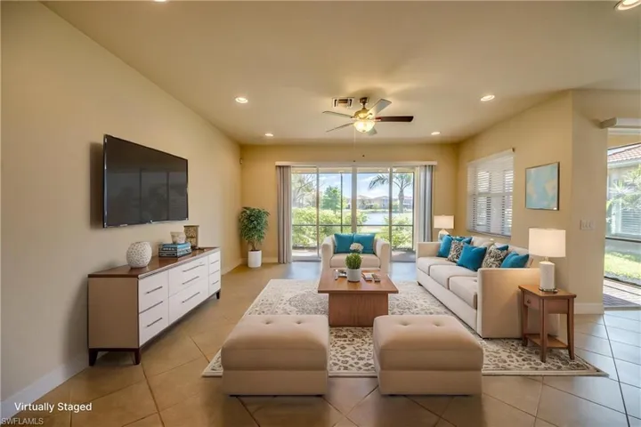 Living room with plenty of natural light, a ceiling fan, and light tile patterned floors