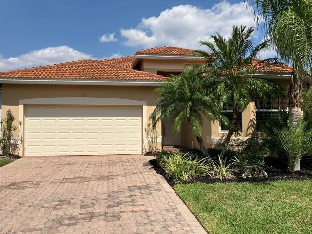Mediterranean / spanish house featuring stucco siding, a tile roof, decorative driveway, and an attached garage