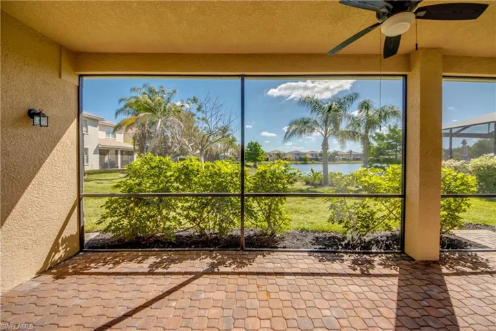 Unfurnished sunroom featuring a water view and a ceiling fan
