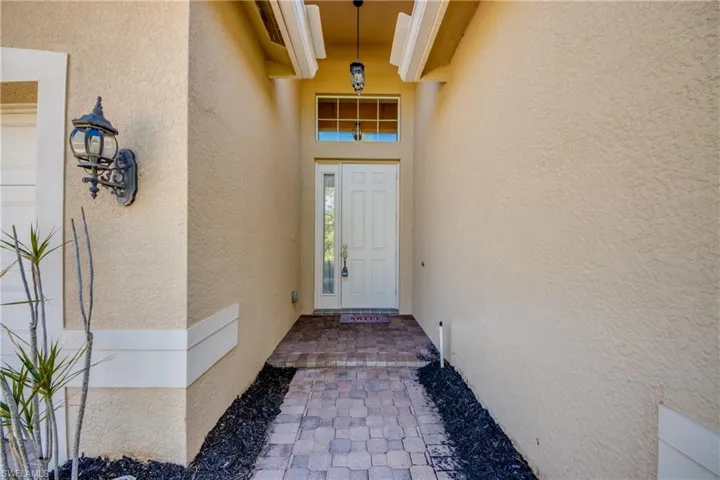 View of exterior entry featuring stucco siding