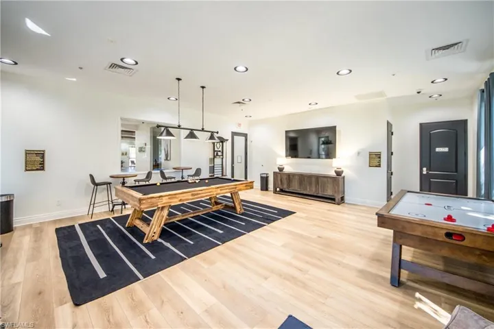 Rec room with pool table, baseboards, light wood finished floors, and visible vents