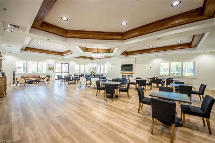 Dining room featuring ornamental molding, a tray ceiling, visible vents, and light wood-type flooring