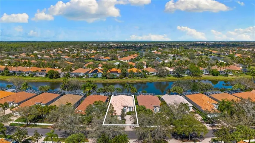 Aerial perspective of suburban area featuring a nearby body of water and property parcel outlined