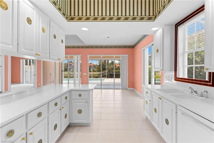 Kitchen featuring white cabinets, recessed lighting, and light tile patterned floors