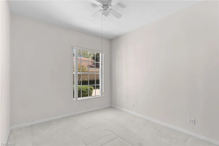 Spare room with light carpet and a ceiling fan