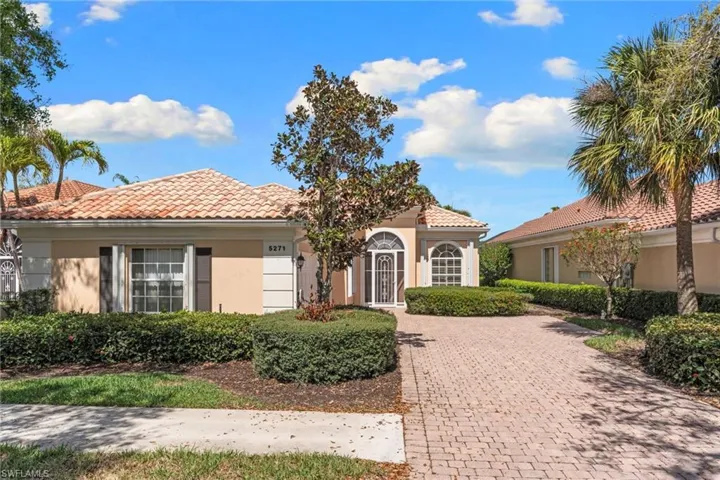 Mediterranean / spanish home with stucco siding, a tile roof, and decorative driveway
