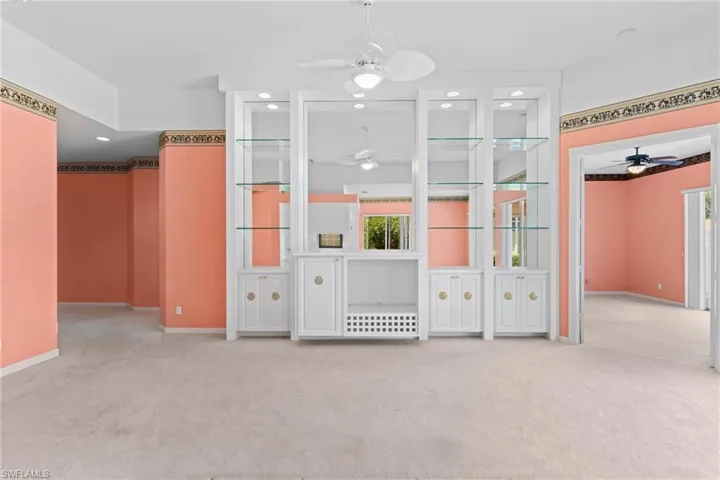 Empty room with ceiling fan, light colored carpet, and recessed lighting