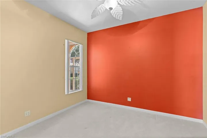Unfurnished room with ceiling fan and light carpet