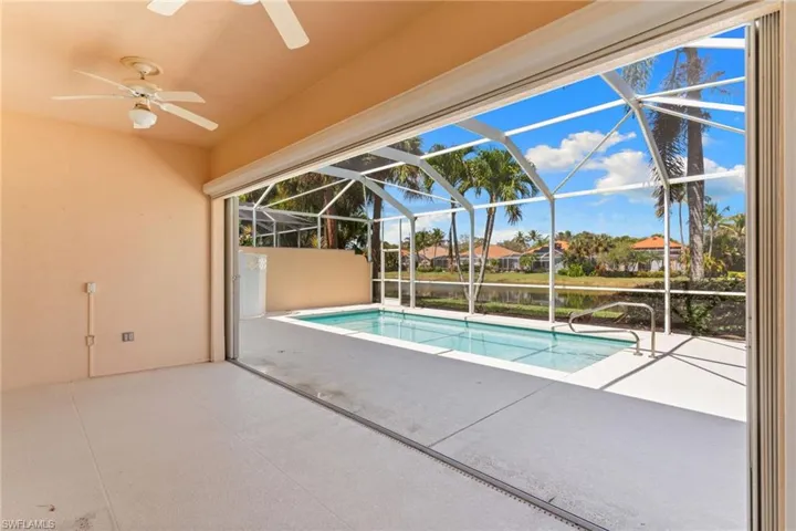 Outdoor pool featuring a patio area, a sunroom, a lanai, and a residential view