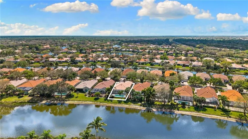 Aerial perspective of suburban area with a nearby body of water