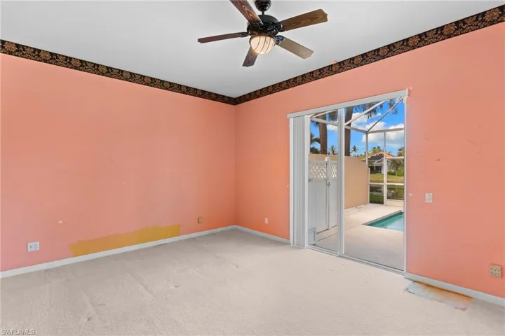 Spare room featuring a ceiling fan, carpet, and a sunroom