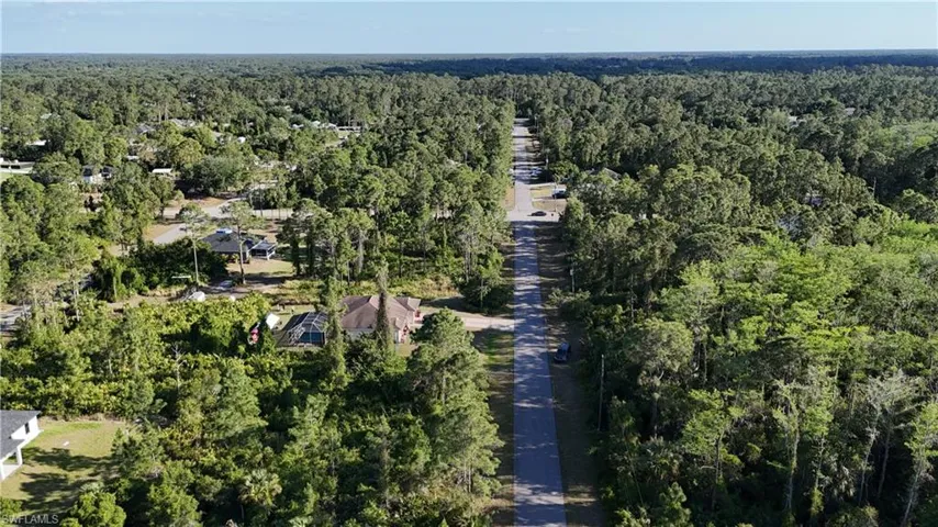 Drone / aerial view featuring a wooded view
