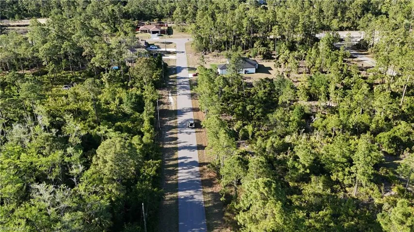 Birds eye view of property with a forest view