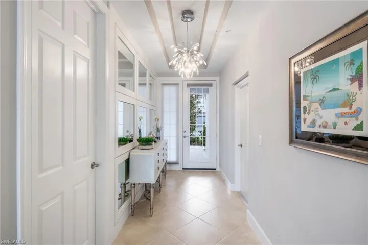 Entrance foyer featuring a chandelier and light tile patterned flooring