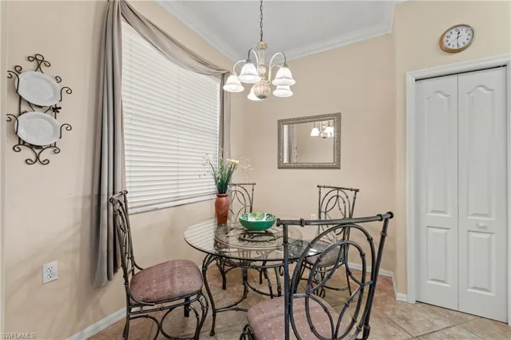 Dining space featuring crown molding and an inviting chandelier