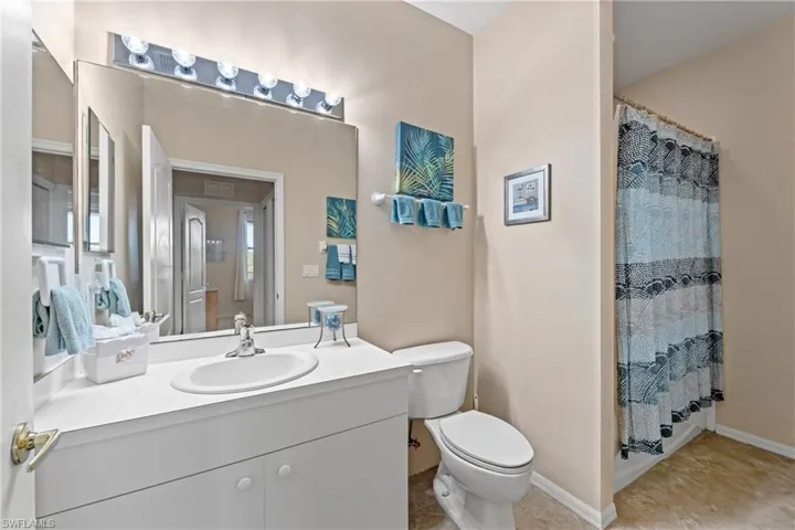 Bathroom featuring tile patterned flooring, vanity, and toilet