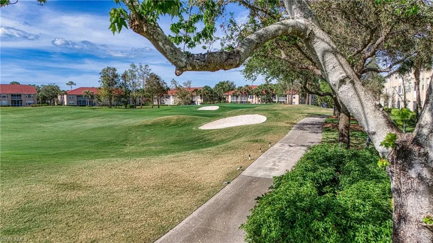 View of property's community with a lawn
