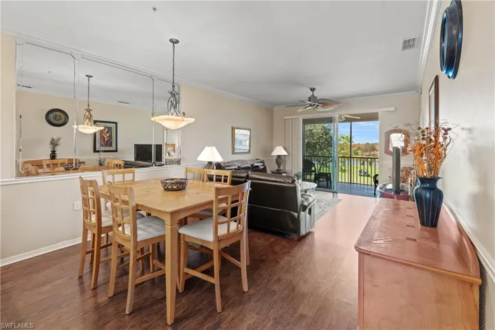 Dining room featuring crown molding, ceiling fan, and dark hardwood / wood-style floors