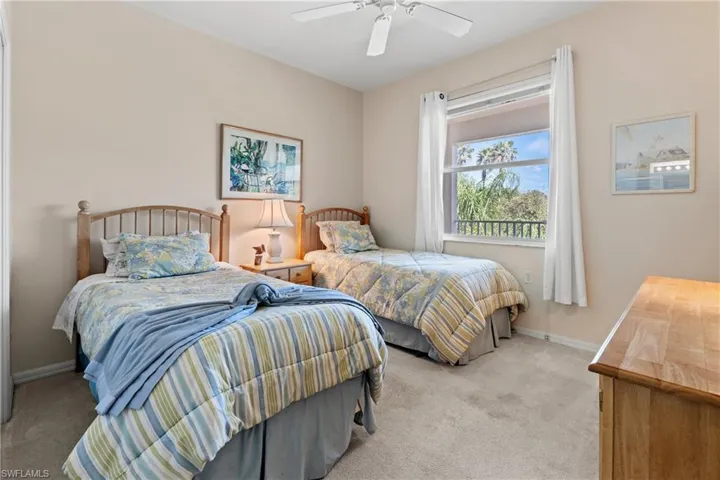 Carpeted bedroom featuring ceiling fan