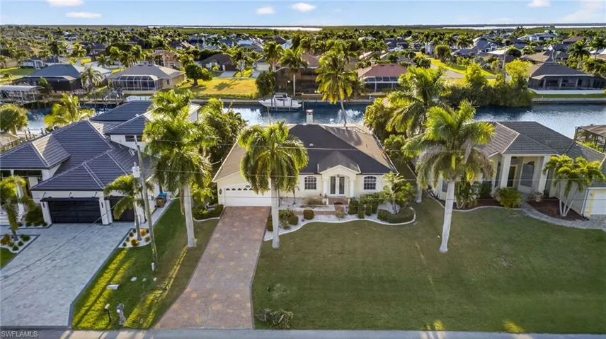Aerial perspective of suburban area featuring a nearby body of water