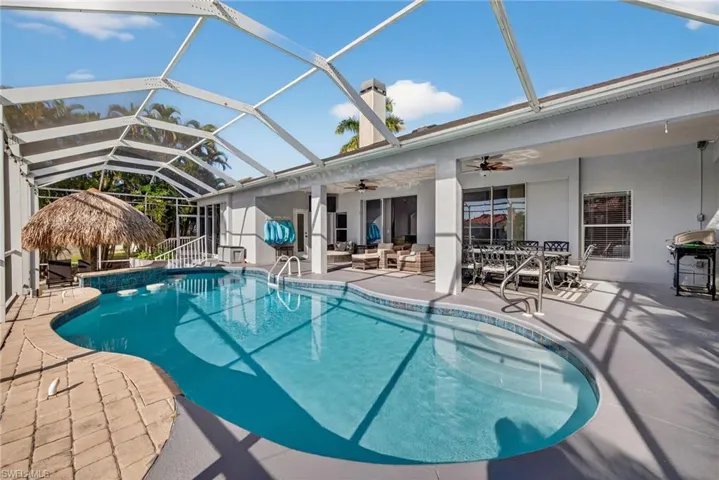 Swimming pool featuring a patio area, outdoor lounge area, a sunroom, a lanai, and a ceiling fan