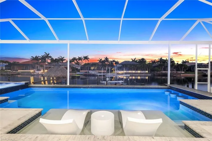 Pool at dusk with a lanai
