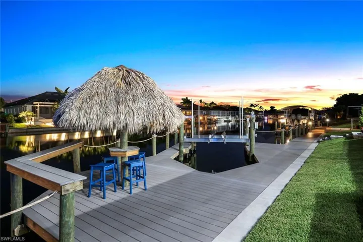 View of dock featuring a lawn