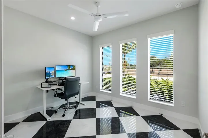 Office space featuring tile floors and ceiling fan