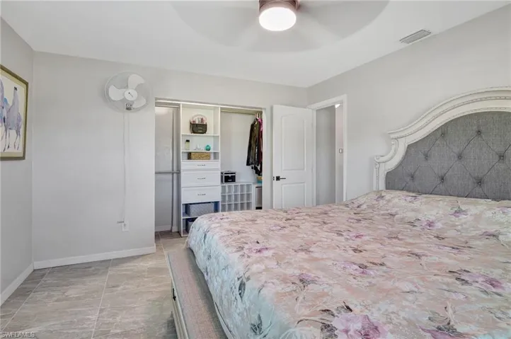 Bedroom with a closet, baseboards, ceiling fan, and visible vents