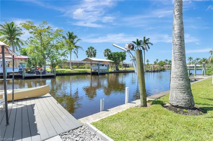Dock area featuring a water view and a yard