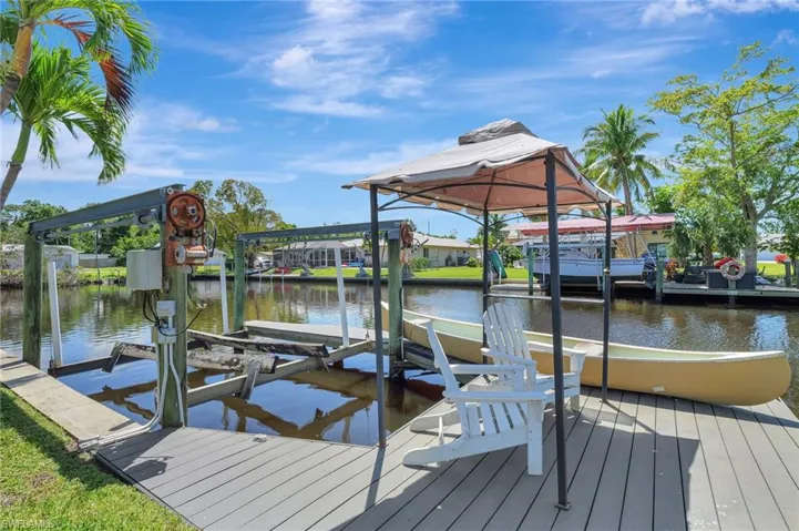 Dock area with a water view and boat lift