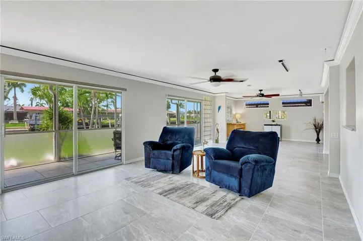 Living room featuring baseboards and a ceiling fan