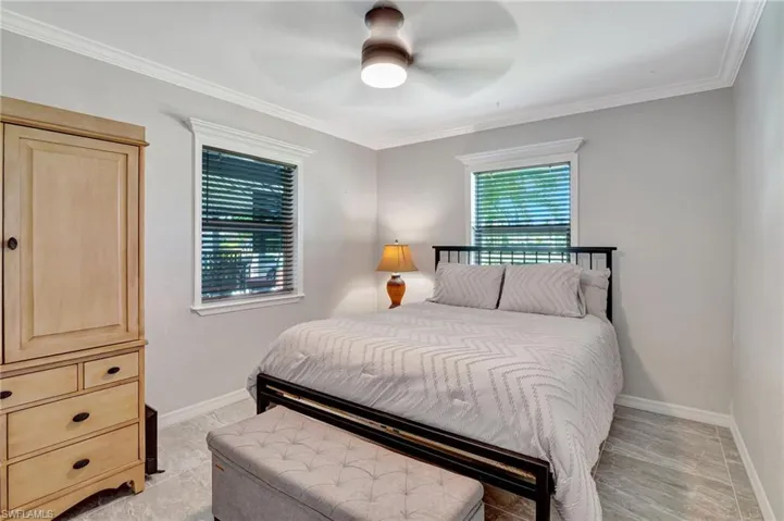 Bedroom featuring crown molding, baseboards, and ceiling fan