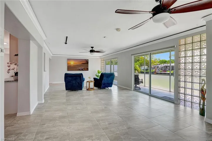 Unfurnished room featuring crown molding, baseboards, and ceiling fan