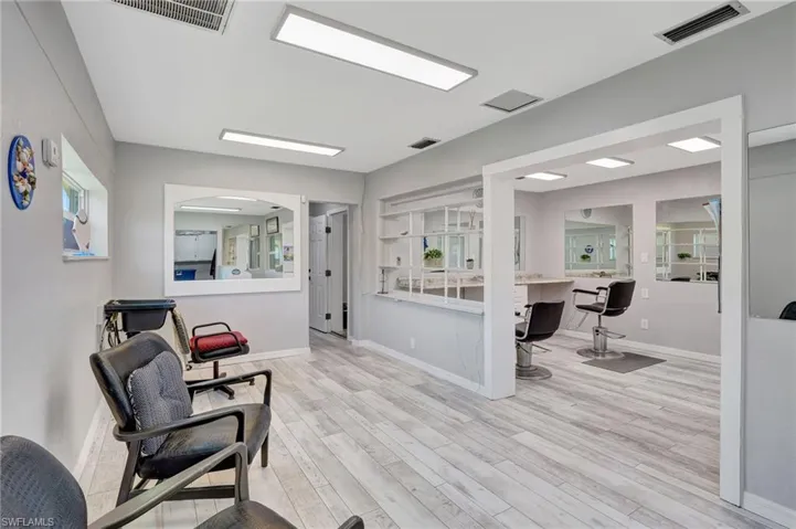 Living area featuring baseboards, visible vents, and wood finished floors