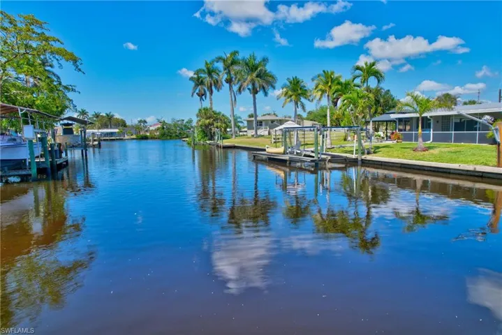 View of dock with a lawn, a water view, and boat lift